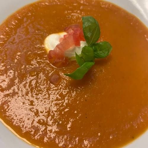 Tomato & roasted sweet pepper soup finished with tomato concasse & soured cream   