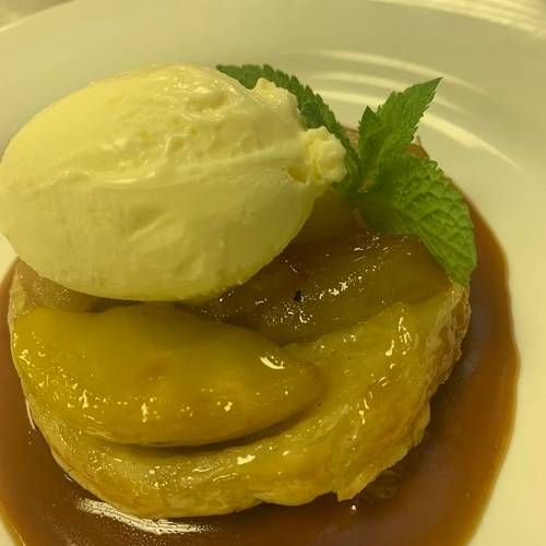 Individual apple tarte tatin, rich caramel sauce & vanilla cream   